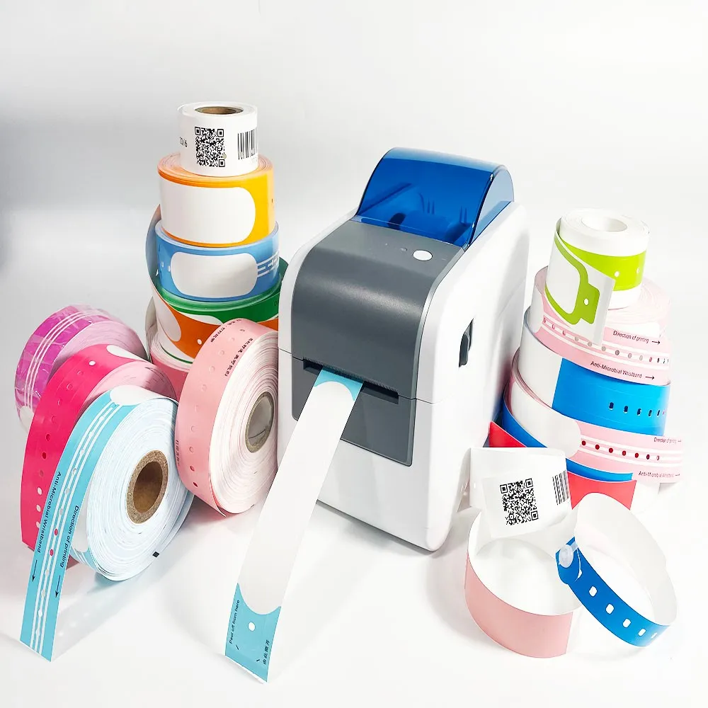 All-in-One Thermal Wristband Printing Solution with Multi-Color Supplies – This compact thermal wristband printer (featuring a blue top cover) is paired with a full range of disposable thermal wristband rolls in vibrant colors (pink, blue, green, orange, white). The wristbands support QR code and barcode printing, making them ideal for patient identification, newborn tracking, and visitor management in hospitals, clinics, and medical centers across the US and European healthcare markets.