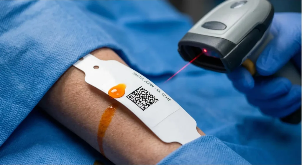 Durable thermal surgical wristband showing iodine resistance and 2D barcode readability for positive patient identification in the operating room.